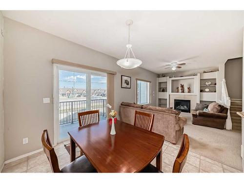 703-720 Willowbrook Road Nw, Airdrie, AB - Indoor Photo Showing Dining Room With Fireplace