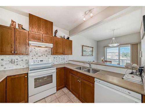 703-720 Willowbrook Road Nw, Airdrie, AB - Indoor Photo Showing Kitchen With Double Sink