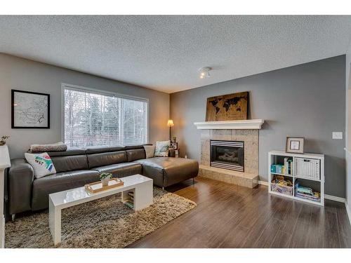 559 Douglas Glen Boulevard Se, Calgary, AB - Indoor Photo Showing Living Room With Fireplace