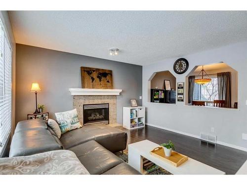 559 Douglas Glen Boulevard Se, Calgary, AB - Indoor Photo Showing Living Room With Fireplace