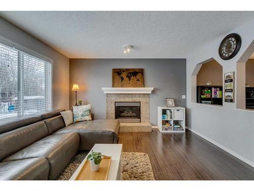 559 Douglas Glen Boulevard Se, Calgary, AB - Indoor Photo Showing Living Room With Fireplace