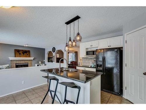 559 Douglas Glen Boulevard Se, Calgary, AB - Indoor Photo Showing Kitchen With Fireplace With Double Sink