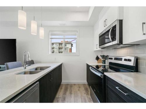 36 Spring Creek Common Sw, Calgary, AB - Indoor Photo Showing Kitchen With Stainless Steel Kitchen With Double Sink With Upgraded Kitchen