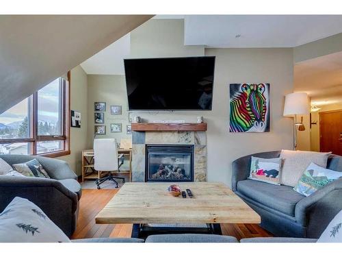 302-1002 8 Avenue, Canmore, AB - Indoor Photo Showing Living Room With Fireplace