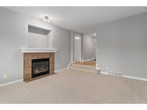 242 Covemeadow Bay Ne, Calgary, AB - Indoor Photo Showing Living Room With Fireplace