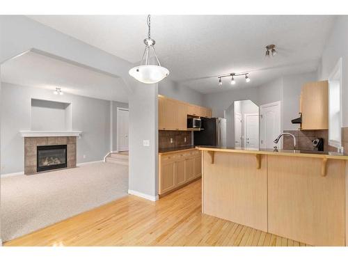 242 Covemeadow Bay Ne, Calgary, AB - Indoor Photo Showing Kitchen With Fireplace