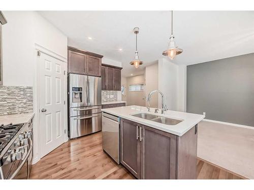 67 Sundown Terrace, Cochrane, AB - Indoor Photo Showing Kitchen With Double Sink With Upgraded Kitchen