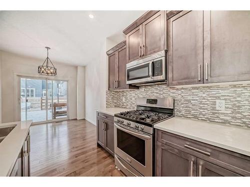 67 Sundown Terrace, Cochrane, AB - Indoor Photo Showing Kitchen With Upgraded Kitchen