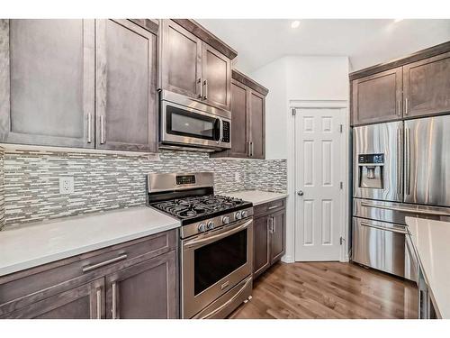 67 Sundown Terrace, Cochrane, AB - Indoor Photo Showing Kitchen With Upgraded Kitchen