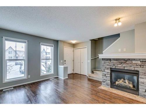 140 Elgin Point Se, Calgary, AB - Indoor Photo Showing Living Room With Fireplace