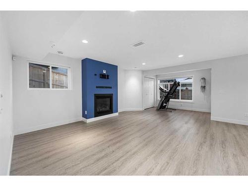 1108 Veterans Avenue, Crossfield, AB - Indoor Photo Showing Living Room With Fireplace