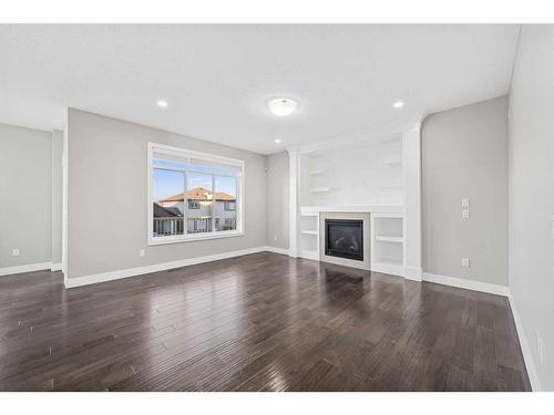 1108 Veterans Avenue, Crossfield, AB - Indoor Photo Showing Living Room With Fireplace