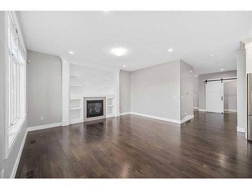 1108 Veterans Avenue, Crossfield, AB - Indoor Photo Showing Living Room With Fireplace