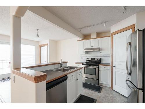 84 West Springs Gate Sw, Calgary, AB - Indoor Photo Showing Kitchen With Double Sink