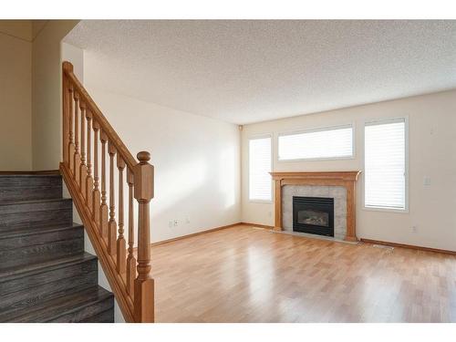 84 West Springs Gate Sw, Calgary, AB - Indoor Photo Showing Living Room With Fireplace