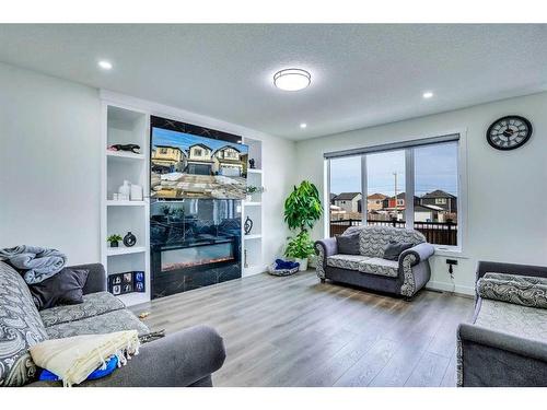 203 Saddlecrest Grove Ne, Calgary, AB - Indoor Photo Showing Living Room With Fireplace