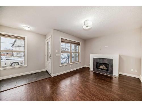 304-50 Belgian Lane, Cochrane, AB - Indoor Photo Showing Living Room With Fireplace