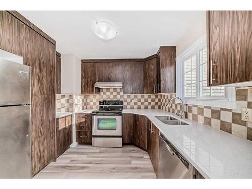 3 Templeby Way Ne, Calgary, AB - Indoor Photo Showing Kitchen With Stainless Steel Kitchen With Double Sink