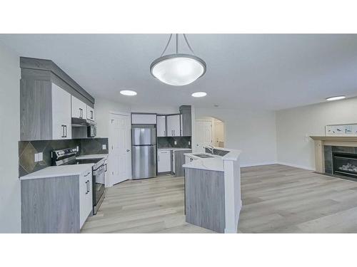 246 Saddlefield Place Ne, Calgary, AB - Indoor Photo Showing Kitchen With Fireplace