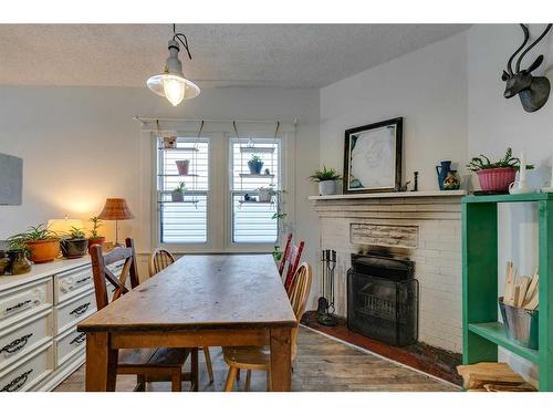 910 5 Street Nw, Calgary, AB - Indoor Photo Showing Dining Room With Fireplace