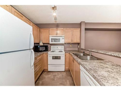 9119-70 Panamount Drive Nw, Calgary, AB - Indoor Photo Showing Kitchen With Double Sink