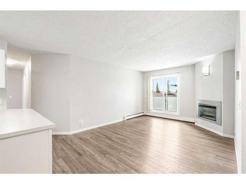 2821-3400 Edenwold Heights Nw, Calgary, AB - Indoor Photo Showing Other Room With Fireplace