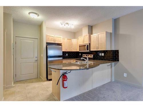 2204-11811 Lake Fraser Drive Se, Calgary, AB - Indoor Photo Showing Kitchen With Double Sink