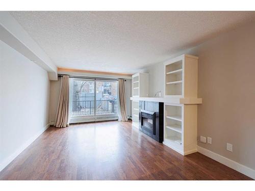 110-355 5 Avenue Ne, Calgary, AB - Indoor Photo Showing Living Room With Fireplace