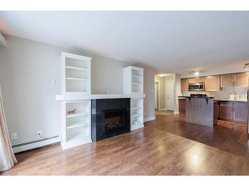 110-355 5 Avenue Ne, Calgary, AB - Indoor With Fireplace