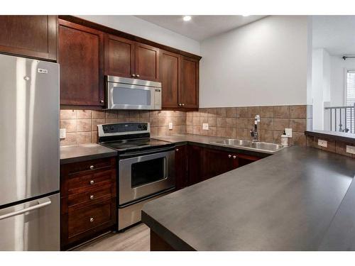 21-2040 35 Avenue Sw, Calgary, AB - Indoor Photo Showing Kitchen With Double Sink