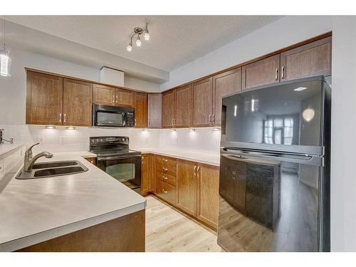 126-1 Crystal Green Lane, Okotoks, AB - Indoor Photo Showing Kitchen With Double Sink