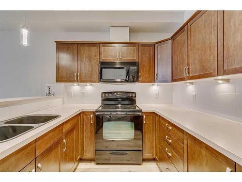 126-1 Crystal Green Lane, Okotoks, AB - Indoor Photo Showing Kitchen With Double Sink