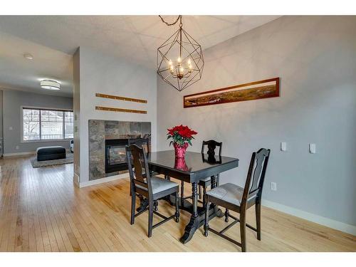 86 Cougartown Circle Sw, Calgary, AB - Indoor Photo Showing Dining Room With Fireplace