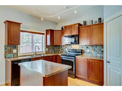 86 Cougartown Circle Sw, Calgary, AB - Indoor Photo Showing Kitchen With Double Sink