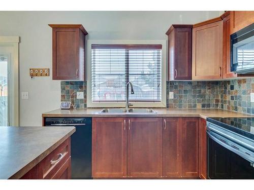 86 Cougartown Circle Sw, Calgary, AB - Indoor Photo Showing Kitchen With Double Sink