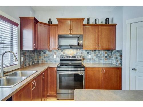 86 Cougartown Circle Sw, Calgary, AB - Indoor Photo Showing Kitchen With Double Sink