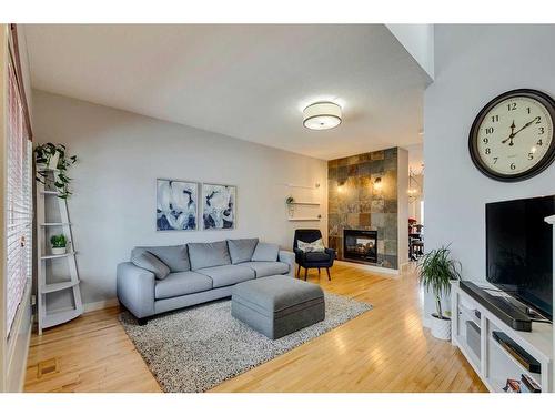 86 Cougartown Circle Sw, Calgary, AB - Indoor Photo Showing Living Room With Fireplace