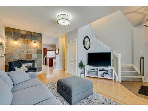 86 Cougartown Circle Sw, Calgary, AB - Indoor Photo Showing Living Room With Fireplace