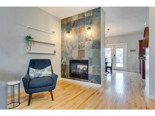 86 Cougartown Circle Sw, Calgary, AB - Indoor Photo Showing Living Room With Fireplace