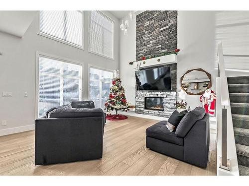 86 West Point Mews Sw, Calgary, AB - Indoor Photo Showing Living Room With Fireplace