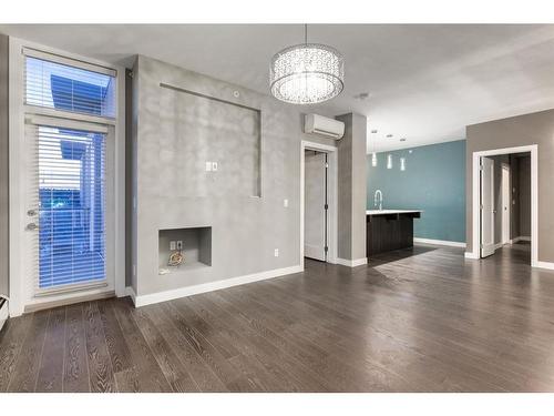 408-119 19 Street Nw, Calgary, AB - Indoor Photo Showing Living Room With Fireplace