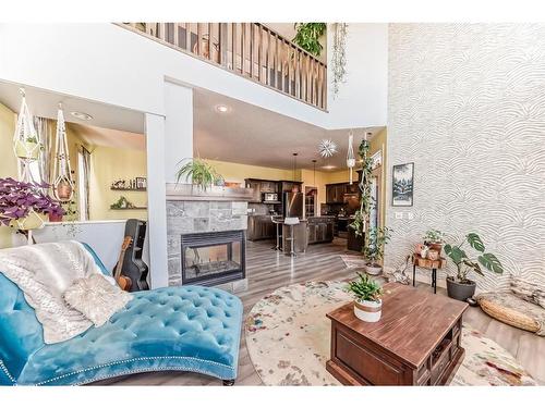 196 Sunset Circle, Cochrane, AB - Indoor Photo Showing Other Room With Fireplace