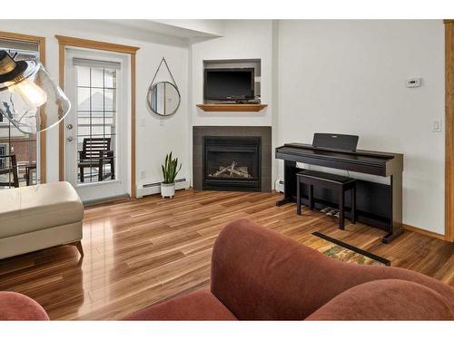 233-223 Tuscany Springs Boulevard Nw, Calgary, AB - Indoor Photo Showing Living Room With Fireplace