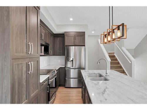 681-101 Sunset Drive, Cochrane, AB - Indoor Photo Showing Kitchen With Stainless Steel Kitchen With Double Sink With Upgraded Kitchen