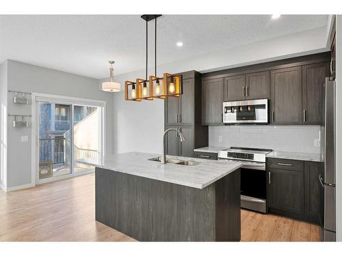 681-101 Sunset Drive, Cochrane, AB - Indoor Photo Showing Kitchen With Upgraded Kitchen