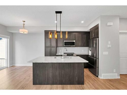 681-101 Sunset Drive, Cochrane, AB - Indoor Photo Showing Kitchen With Stainless Steel Kitchen With Double Sink With Upgraded Kitchen