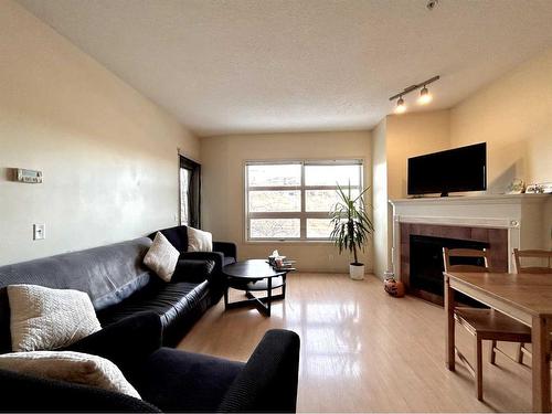 351-333 Riverfront Avenue Se, Calgary, AB - Indoor Photo Showing Living Room With Fireplace