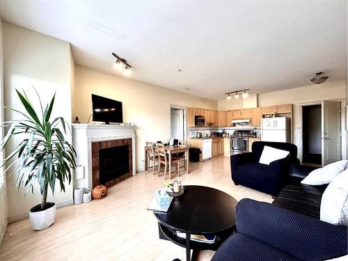 351-333 Riverfront Avenue Se, Calgary, AB - Indoor Photo Showing Living Room With Fireplace