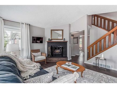 137 Woodfield Close Sw, Calgary, AB - Indoor Photo Showing Living Room With Fireplace