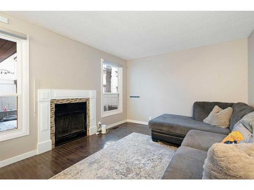 15-3200 60 Street Ne, Calgary, AB - Indoor Photo Showing Living Room With Fireplace